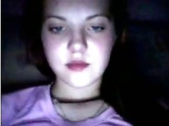 Amateur bruntte teen licks her lips in front of a webcam